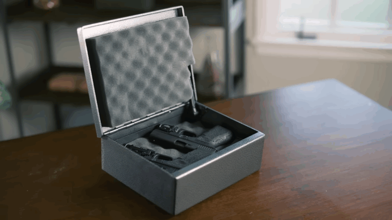 A locked gun case with foam padding securely holding two handguns, showing proper safe firearms storage