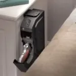 Handgun placed in an unsecured bedside mount showing an example of improper firearms storage in a bedroom setting
