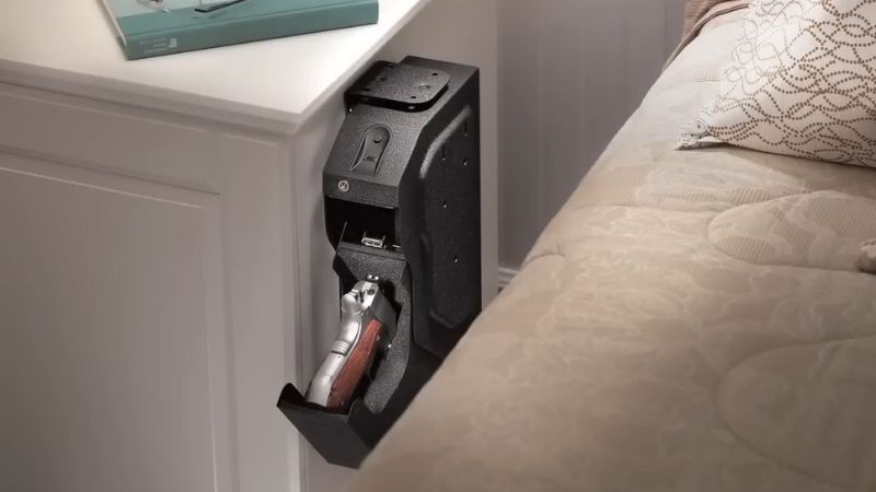 Handgun placed in an unsecured bedside mount showing an example of improper firearms storage in a bedroom setting