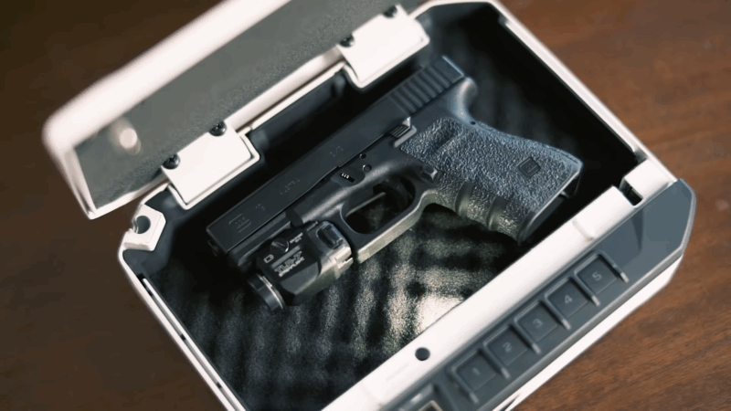 A handgun stored in a biometric safe, showing proper firearm storage