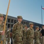 ROTC cadets stand in formation outside during training