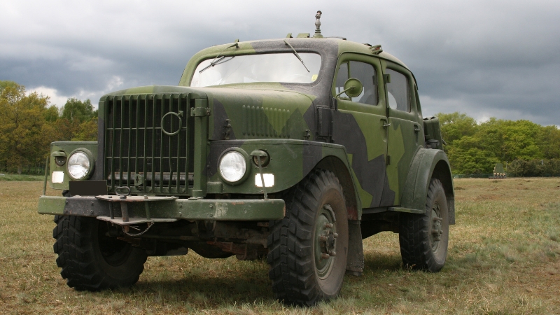 A military vehicle parked on grass under a cloudy sky, related to when the Army may ship your car during a PCS move